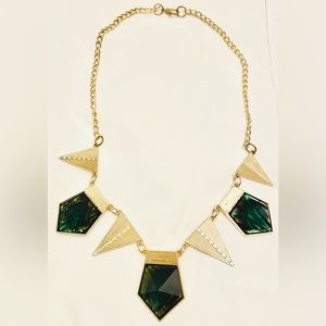 Emerald and gold colored necklace.